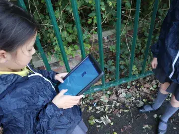 Student mapping habitats on a school site