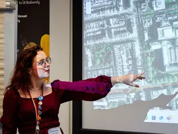 Nathalie Griffiths shows a school habitat map at the front of a class