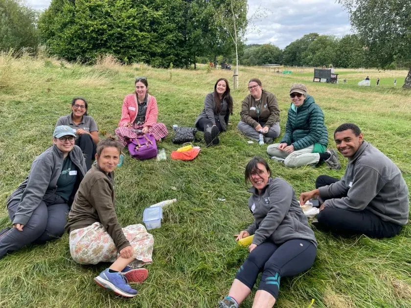 Members of the Nature Park team sitting in a circle on some grass