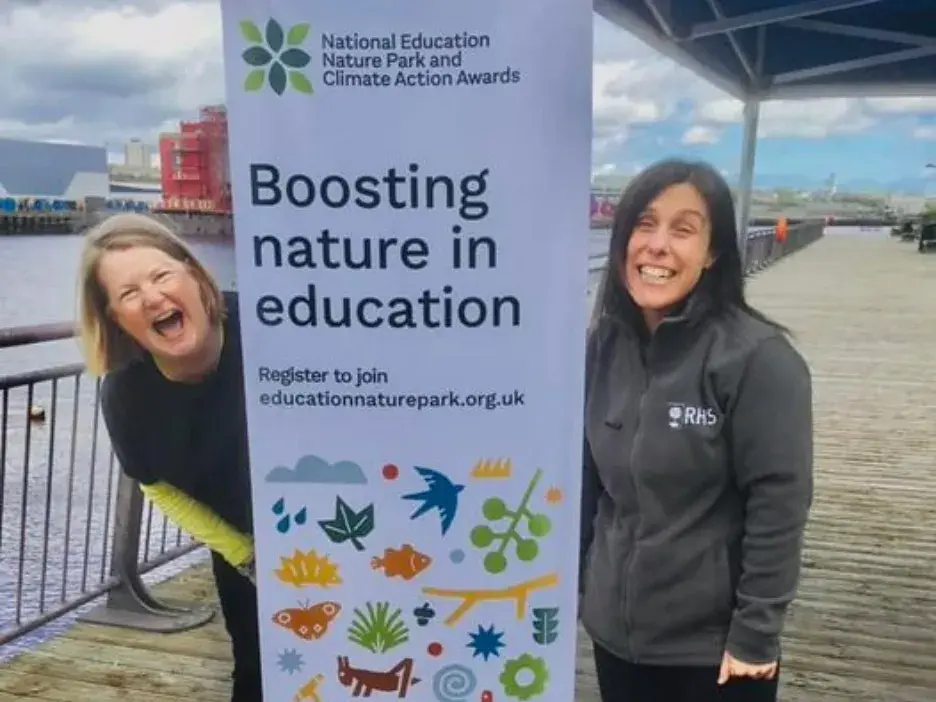 Regional team stand in front of Nature Park banner