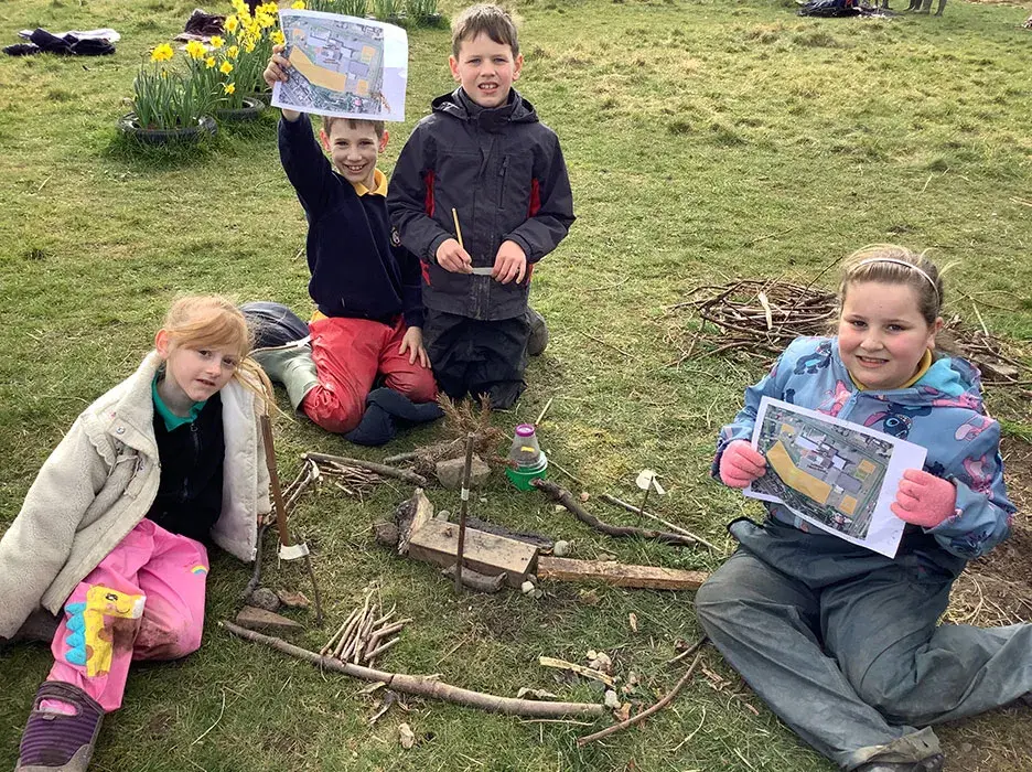 Pupils show the 3D models they have made of their site using natural materials