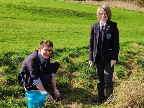 Students planting trees at Lady Manners School